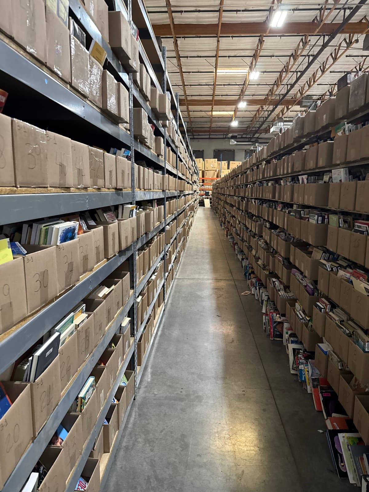 BookDrop warehouse — rows of shelves stocked with books