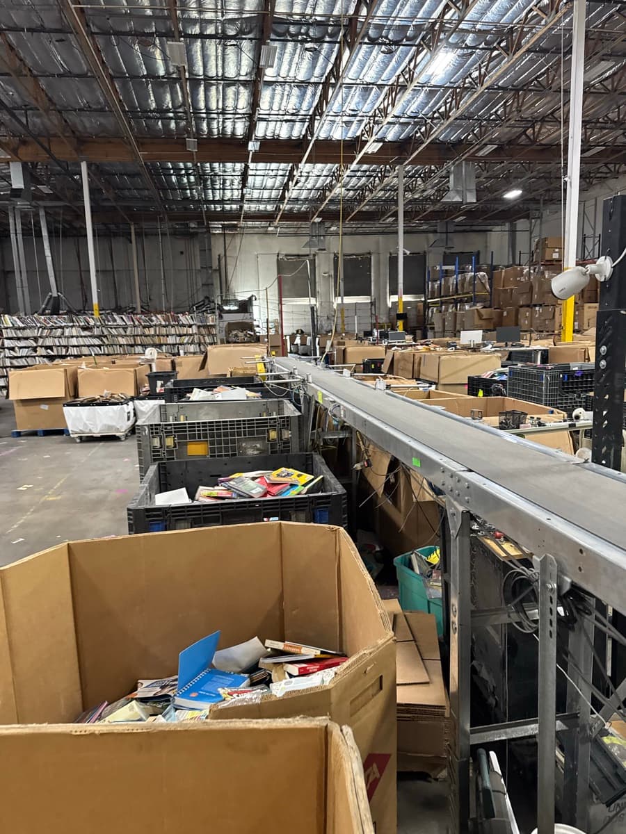 Books moving through the BookDrop sorting conveyor system